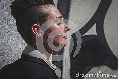 Pretty short hair girl posing against a wall Stock Photo