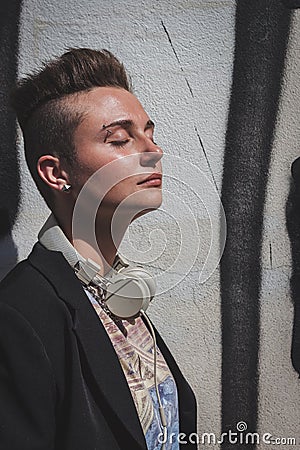 Pretty short hair girl posing against a wall Stock Photo