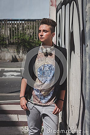 Pretty short hair girl posing against a wall Stock Photo