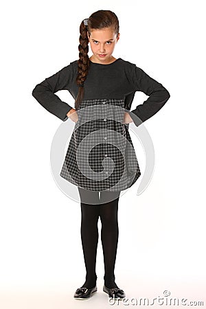 Beautiful schoolgirl posing in business clothes. She is serious and demanding Stock Photo