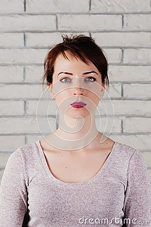 A pretty slim girl with reserved face, blue eyes, pink full lips Stock Photo