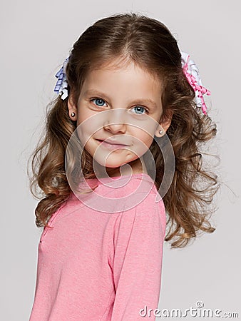 Pretty small girl on the grey background Stock Photo