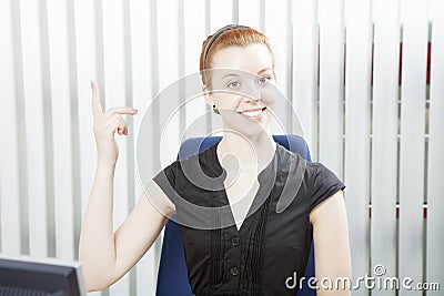 Pretty businesswoman pointing above her head Stock Photo