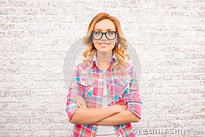 Pretty smart young woman in glases with crossed hands Stock Photo