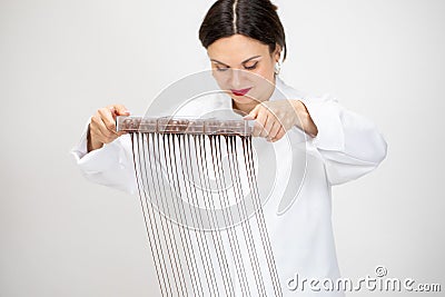 Pretty smiling chocolatier making hand-crafted chocolate candies, dripping down Stock Photo