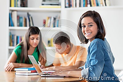 Pretty spanish female student with group of learning students Stock Photo