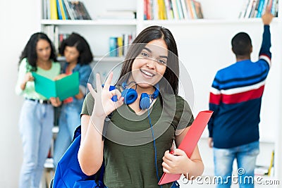 Pretty spanish female student with group of students Stock Photo