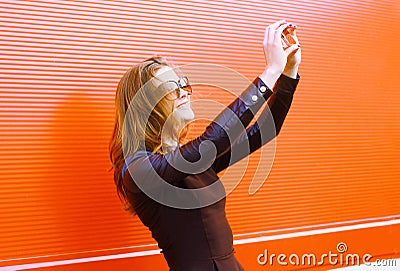 Pretty stylish woman makes self-portrait on the smartphone Stock Photo