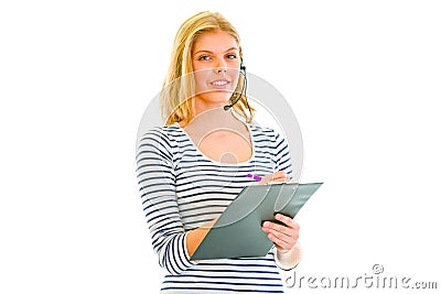 Pretty teen girl in headset writing in clipboard Stock Photo