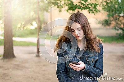 Pretty teen girl using phone in social media Stock Photo