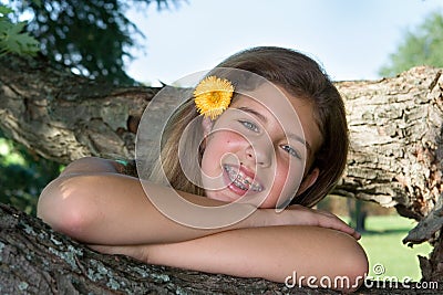 Pretty teenage girl with flower in her hair Stock Photo