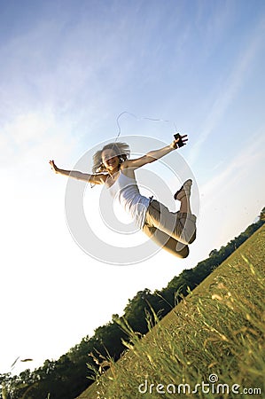 Pretty Teenage Girl listening to portable music player Stock Photo