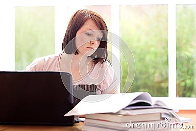 Pretty teenage girl studying at home Stock Photo