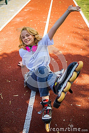 Pretty Teenage Girl Wearing Roller Skaters On The Road In Summe Park. Stock Photo