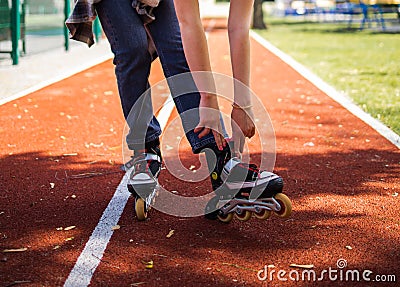 Pretty Teenage Girl Wearing Roller Skaters On The Road In Summe Park. Stock Photo