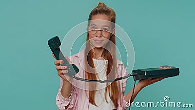 Pretty teenager girl child kid talking on wired vintage telephone of 80s says hey you call me back Stock Photo