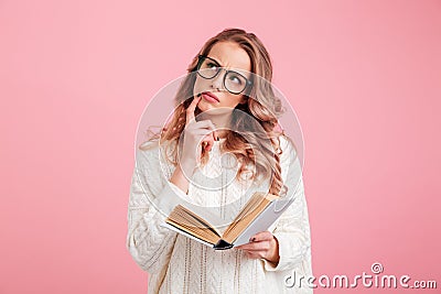 Pretty thinking lady reading book Stock Photo