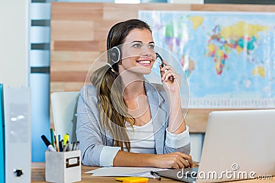 Pretty travel agent speaking to customer Stock Photo