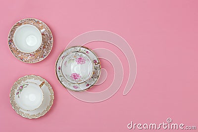Pretty vintage china teacups on a pale pink background Stock Photo