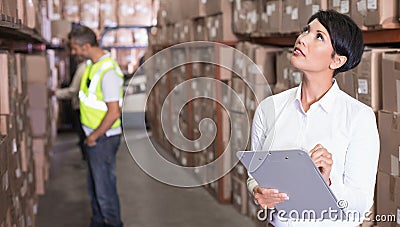 Pretty warehouse manager checking inventory Stock Photo