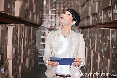 Pretty warehouse manager using tablet pc Stock Photo