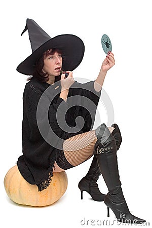 Pretty witch making up Stock Photo