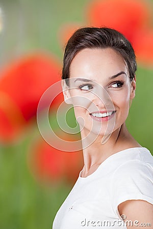 Pretty woman on background with corn poppies Stock Photo