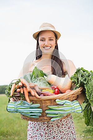 Pretty woman with basket of veg Stock Photo