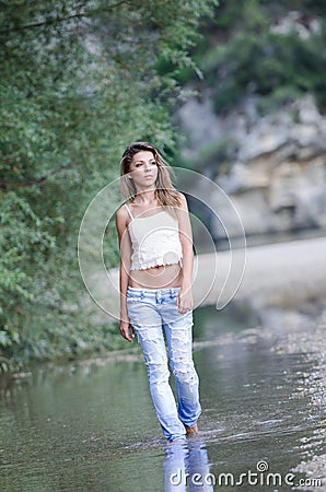 Pretty woman in the beautiful scenery at the river Stock Photo