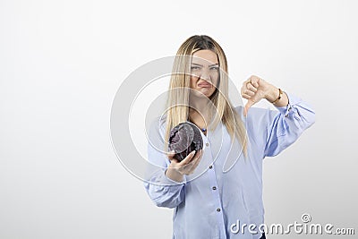 Pretty woman in blue outfit posing with single cabbage on white background Stock Photo