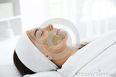 Pretty woman with clay mask on her face Stock Photo