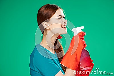 pretty woman with detergent cleaning service green background Stock Photo