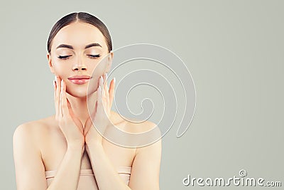Pretty woman face with clear skin and manicure hands. Skincare, bodycare and facial treatment concept Stock Photo