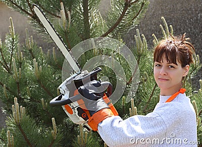 A pretty woman holding a chainsaw Stock Photo