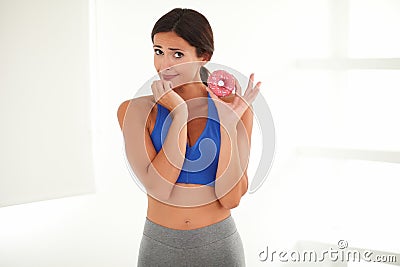 Pretty woman hungry for cake while deciding Stock Photo