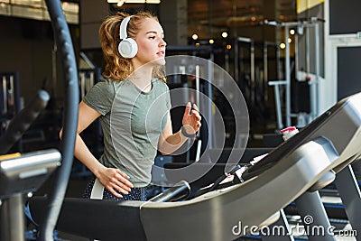 Pretty woman jogging in gym Stock Photo