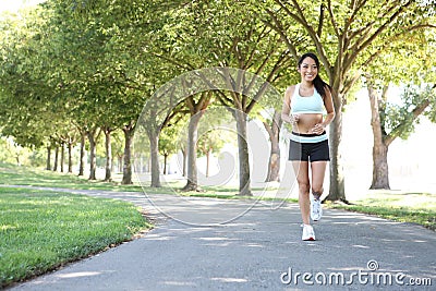 Pretty Woman Jogging in Park Stock Photo