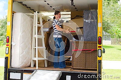 Pretty woman loading a full moving truck Stock Photo