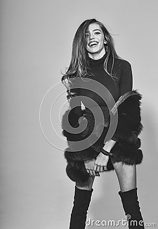 Pretty woman with long hair in fur and jackboot Stock Photo