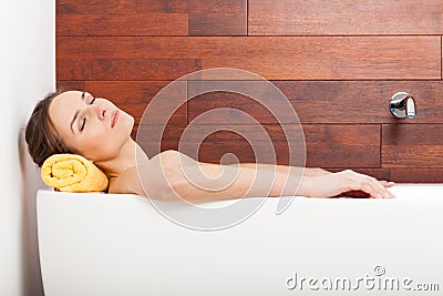 Pretty woman lying in bath Stock Photo