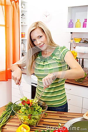 Pretty woman making salad Stock Photo