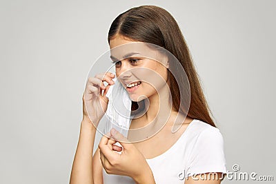 Pretty woman Medical face mask smile safety white t-shirt Stock Photo