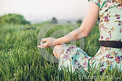 Pretty woman meditate in the park Stock Photo