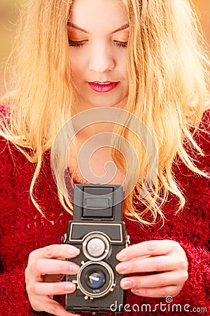 Pretty woman with old vintage camera. Stock Photo