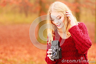 Pretty woman with old vintage camera. Stock Photo