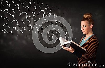 Pretty woman reading a book with question marks coming out from Stock Photo