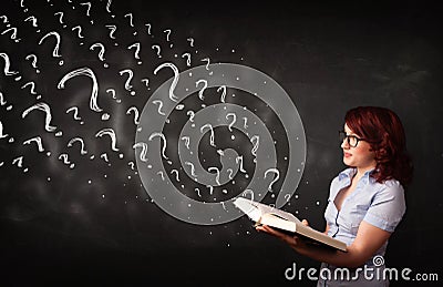 Pretty woman reading a book with question marks coming out from Stock Photo