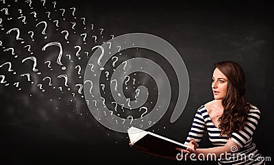 Pretty woman reading a book with question marks coming out from Stock Photo