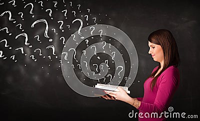 Pretty woman reading a book with question marks coming out from Stock Photo