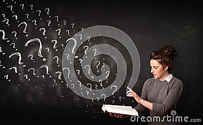 Pretty woman reading a book with question marks coming out from Stock Photo